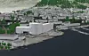 Illustrasjon av et stort, hvitt bygg ved vannet med tett boligbebyggelse i bakgrunnen.